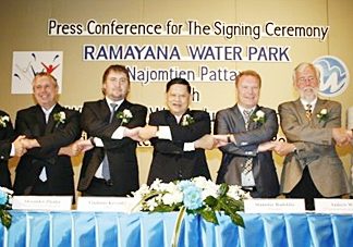 Chumpol Silapa-archa, the Minister Of Tourism & Sports, center, along with Ramayana Water Park and WhiteWater West Industries representatives shake hands at a press conference held April 8 at the Inter Continental Hotel in Bangkok to announce development plans for the water-park project.
